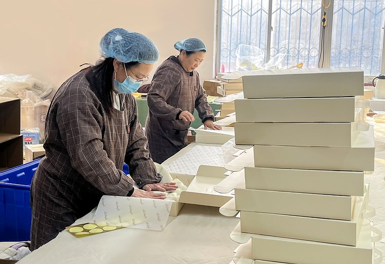 Lemaji factory team preparing baby textile packaging