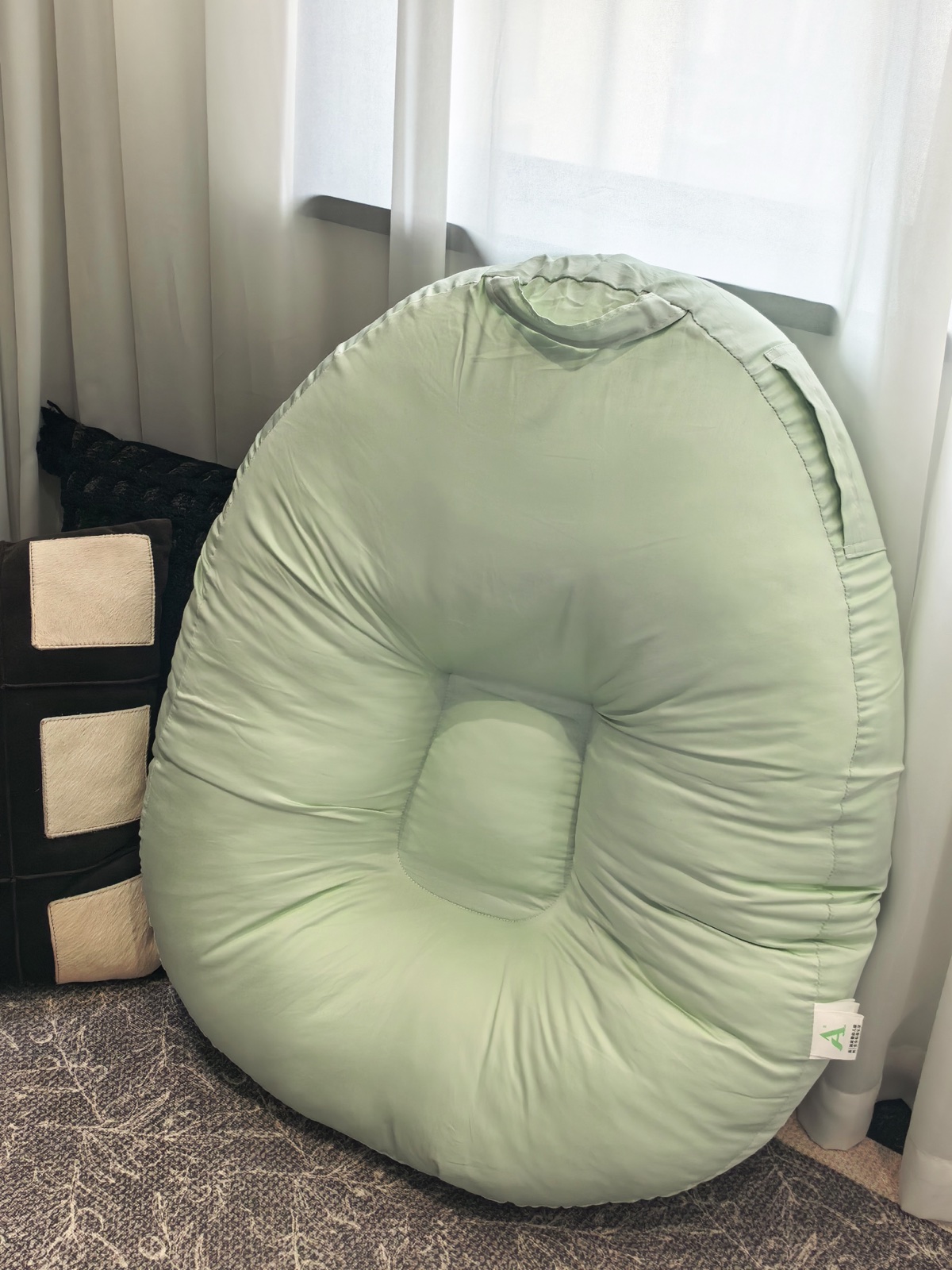 Custom nursing pillow with soft green cover