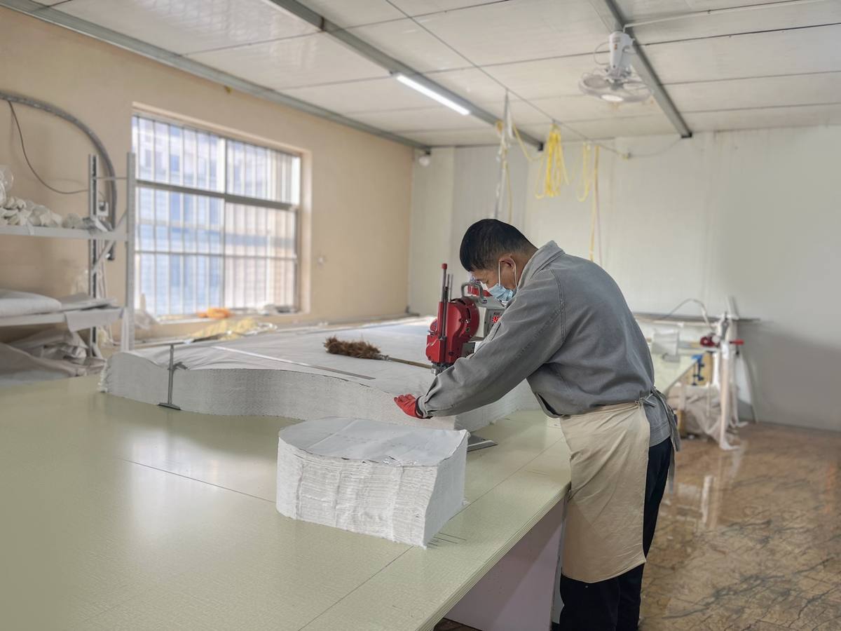 Worker arranging baby textile products before packing