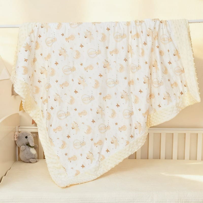 Reversible printed baby blanket with textured dotted reverse side