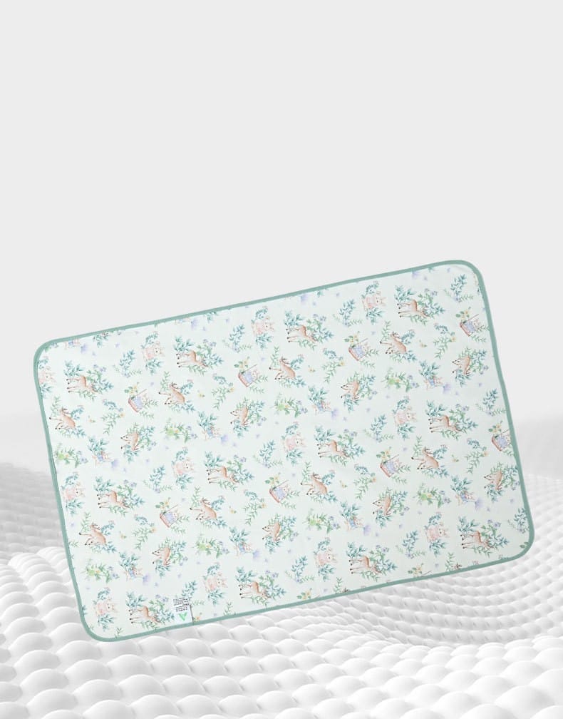 Mint deer print pad on cushioned surface